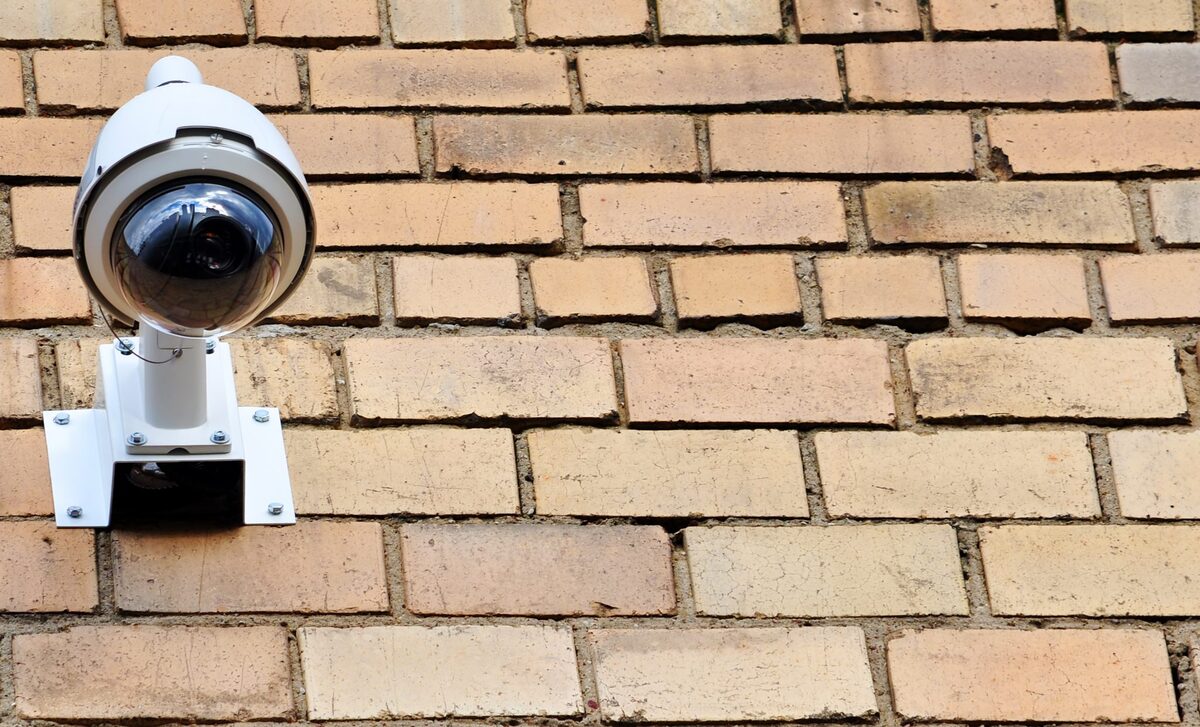 White dome CCTV camera on a brick wall — J4 Security Systems installation